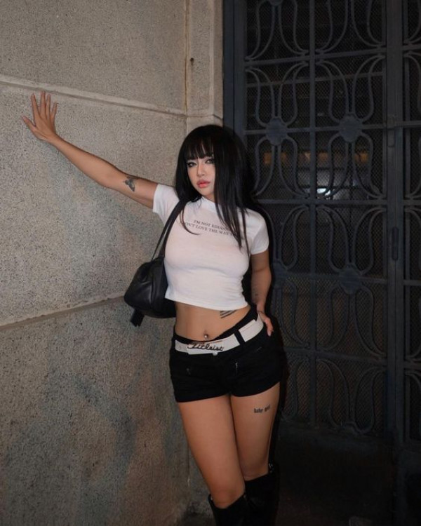 When it comes to city nights, Latina Baddies keeps it crisp with a white top and the darkest black shorts