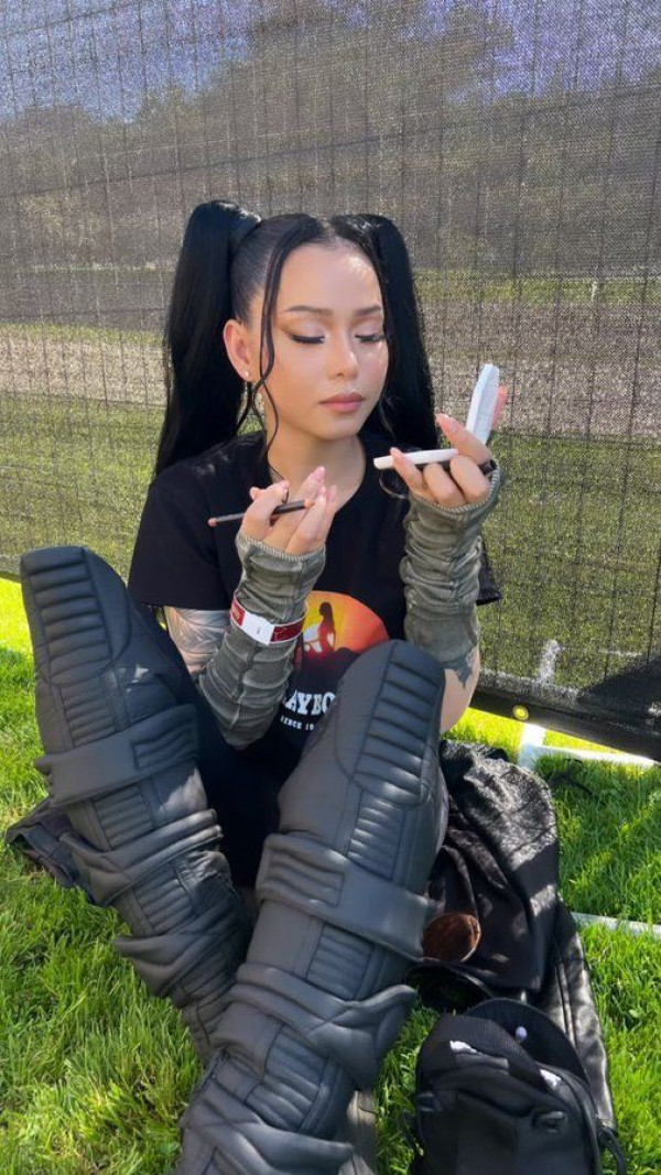 Just her and her kicks, experiencing a moment of Zen with sneaker-boots on the grass.