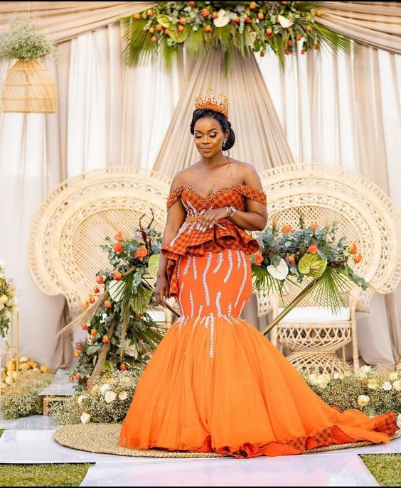 Hey, how about wearing a Orange mermaid-style gown with flowy sleeves on your big day?