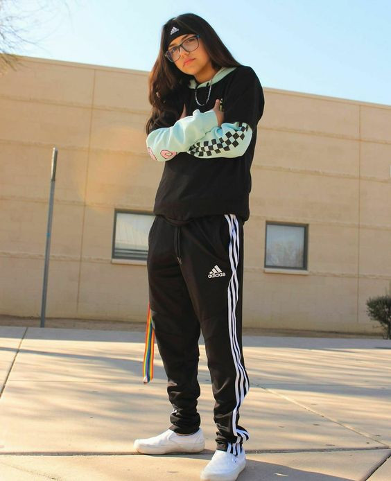 Her tomboy outfit is on point in an Adidas set with a pop of pastel!!