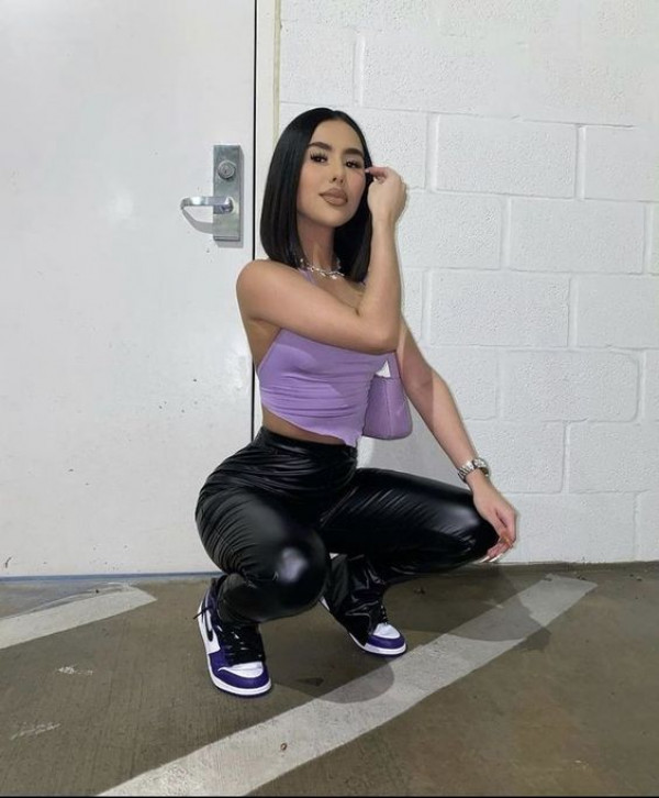 Latina Baddies confidently rocks her purple squat in shiny patent leather!