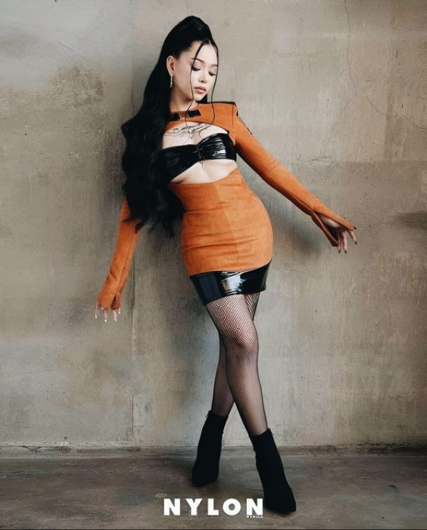 At the forefront of fashion, her legs are adorned in a bold mix of orange and black!