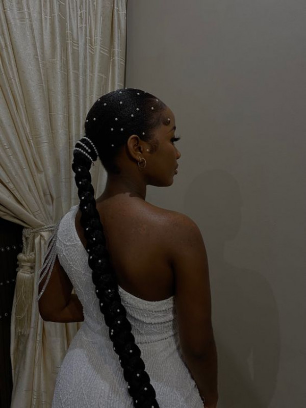 This hairstyle with its bead embellishments is a prom night wonder, reminiscent of styles seen on runway models at fashion week.