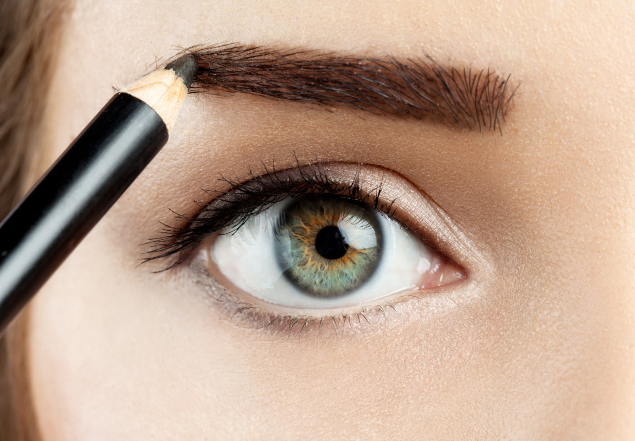 young woman draws a shape eyebrows eyebrow pencil brown